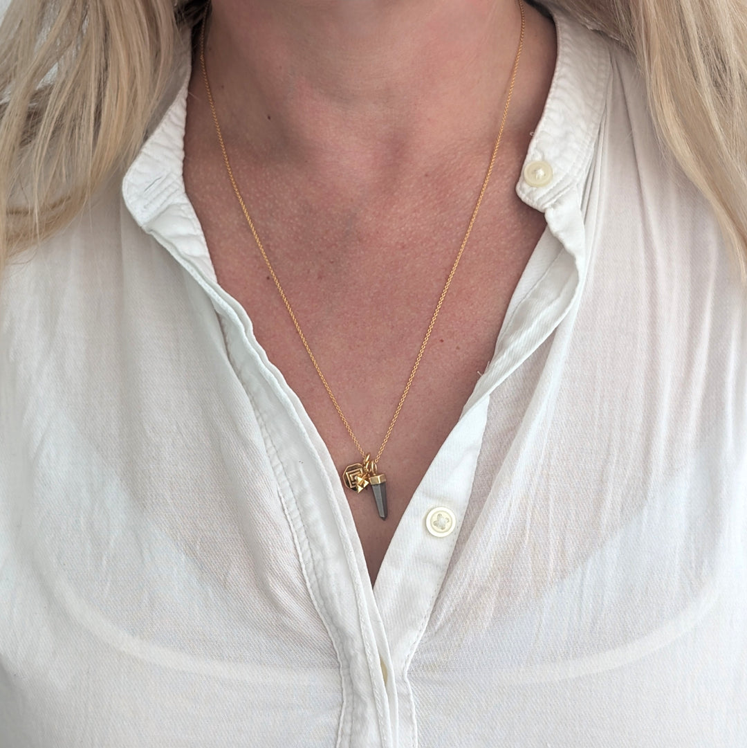 gold necklace with pyrite, tetrahedron star and disc pendant charms