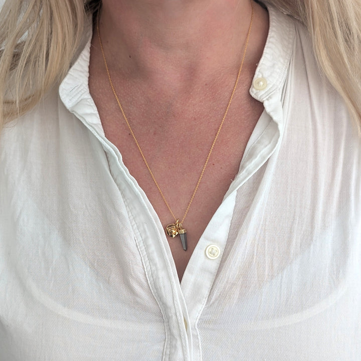 gold necklace with pyrite, tetrahedron star and disc pendant charms