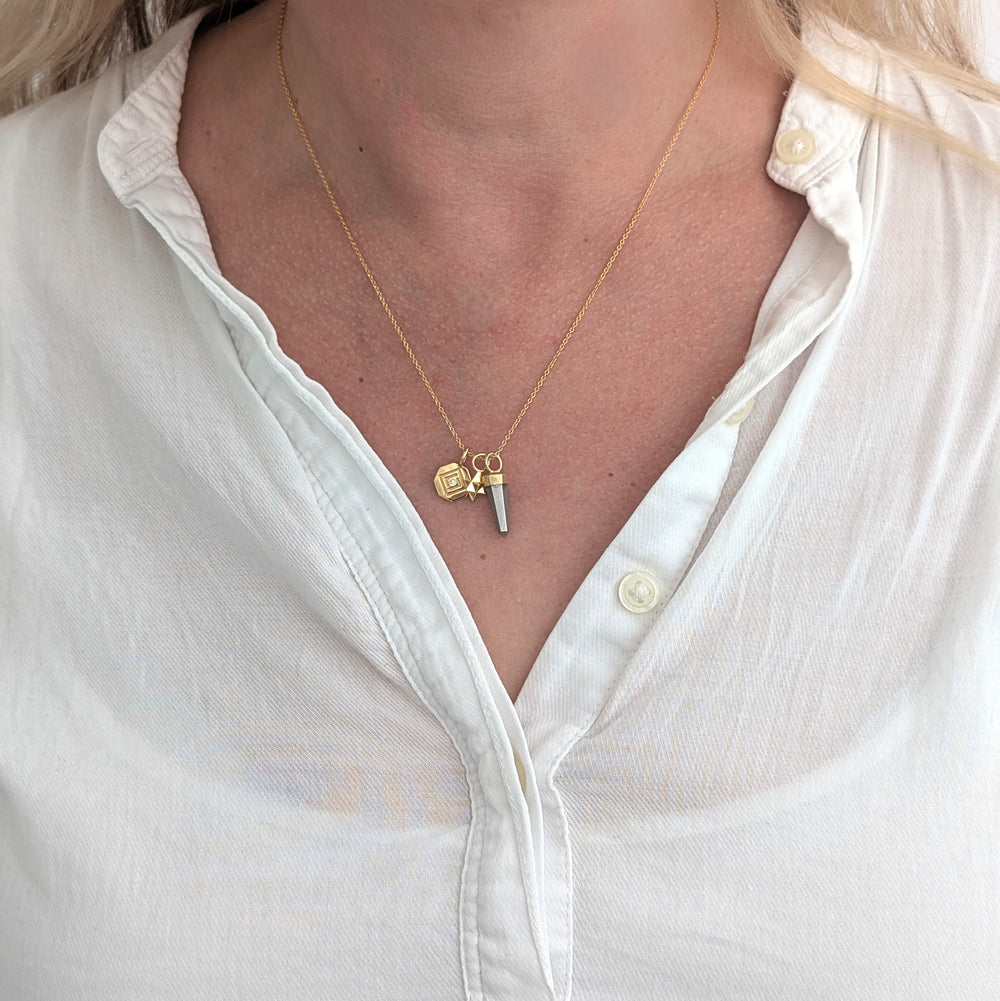 gold necklace with pyrite, tetrahedron star and disc pendant charms