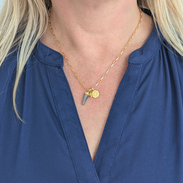 gold necklace with pyrite, tetrahedron star and disc pendant charms