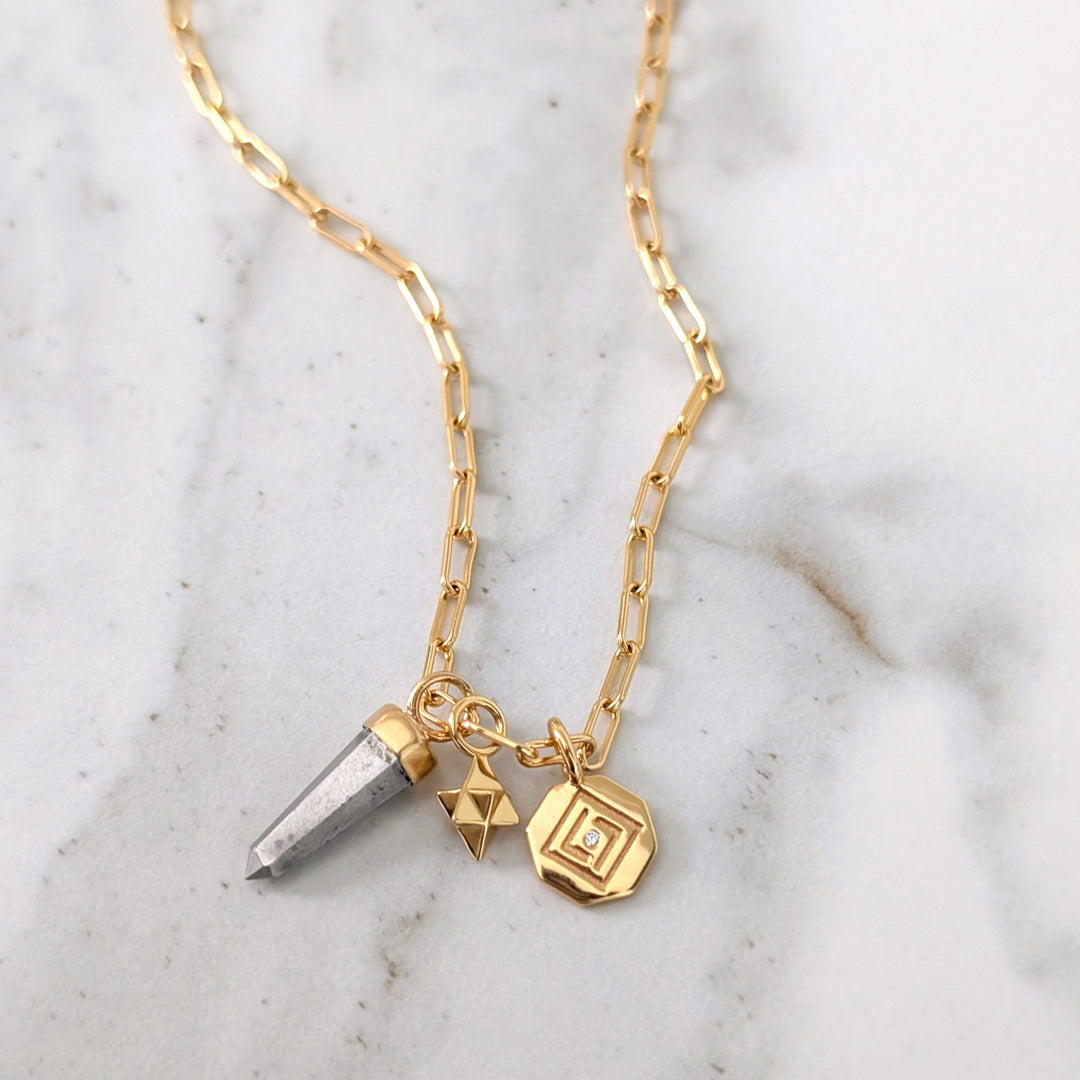 gold necklace with pyrite, tetrahedron star and disc pendant charms