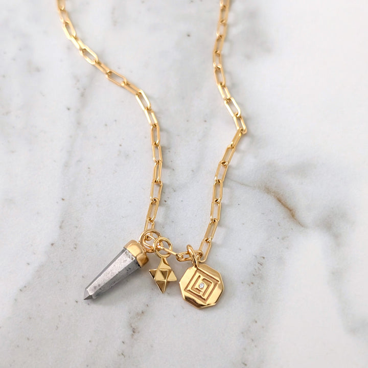 gold necklace with pyrite, tetrahedron star and disc pendant charms