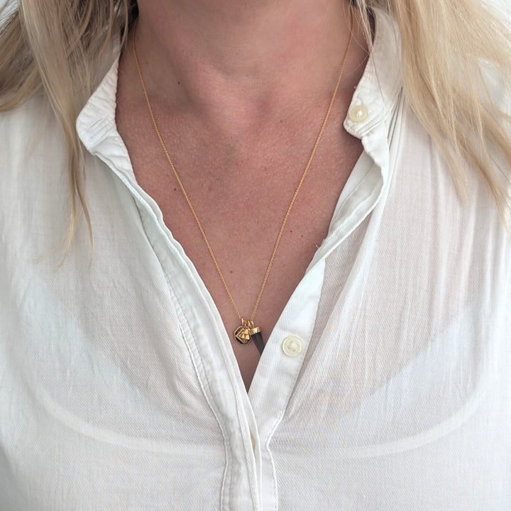 gold necklace with smokey quartz, tetrahedron star and disc pendant charms