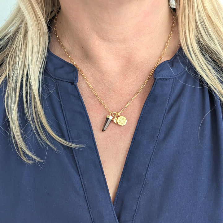 gold necklace with smokey quartz, tetrahedron star and disc pendant charms