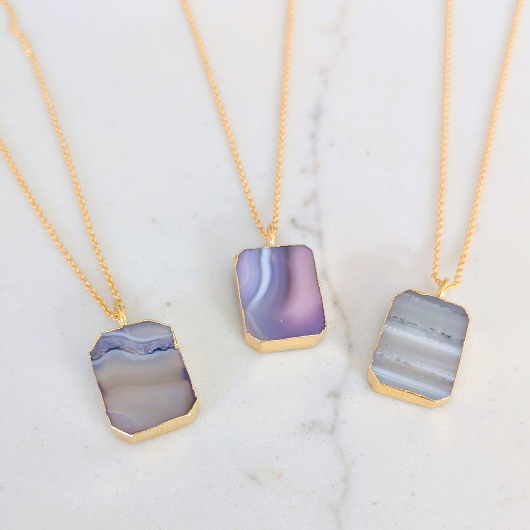 Three gold amethyst strata rectangular pendant necklaces 