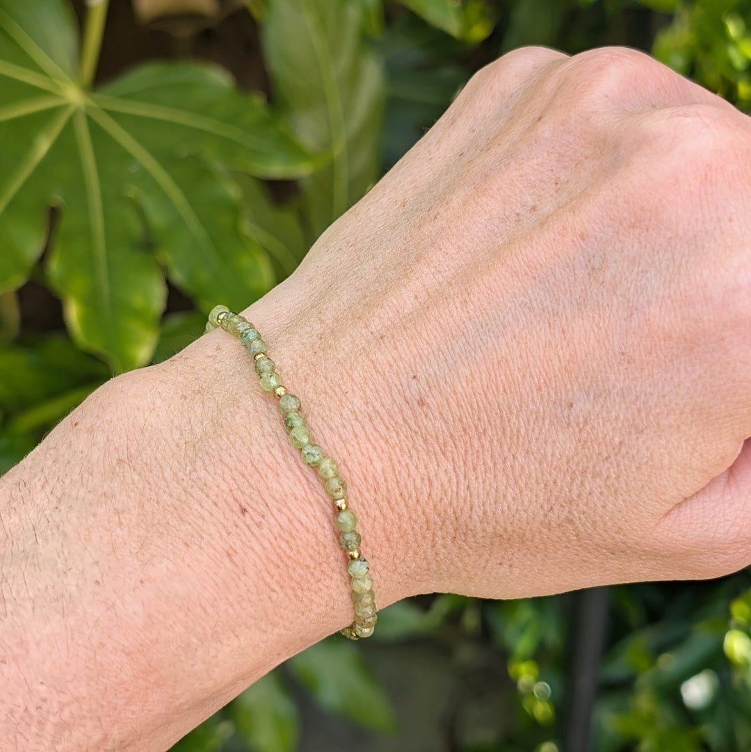 green peridot gemstone and gold bead bracelet 