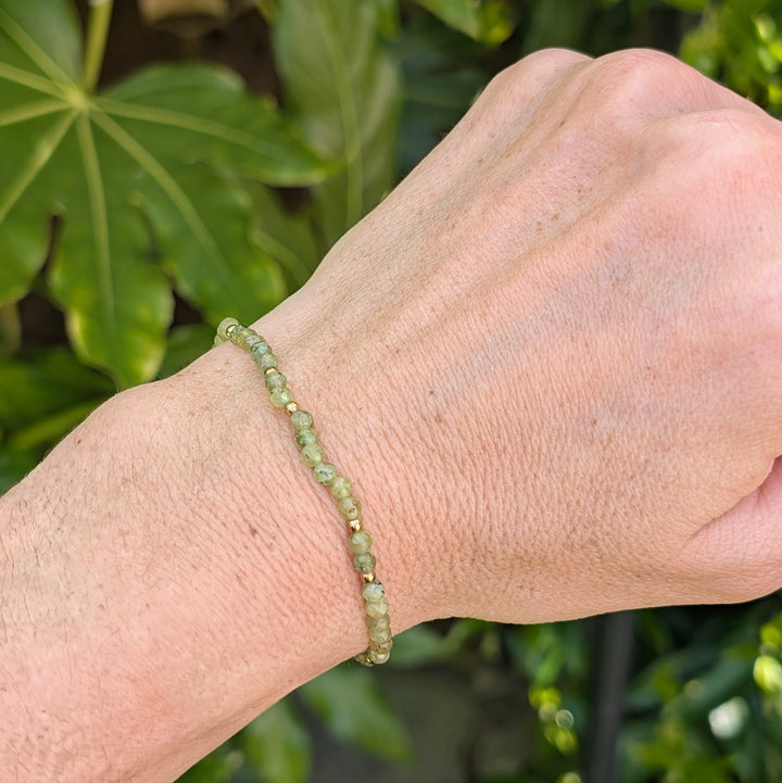 green peridot gemstone and gold bead bracelet 
