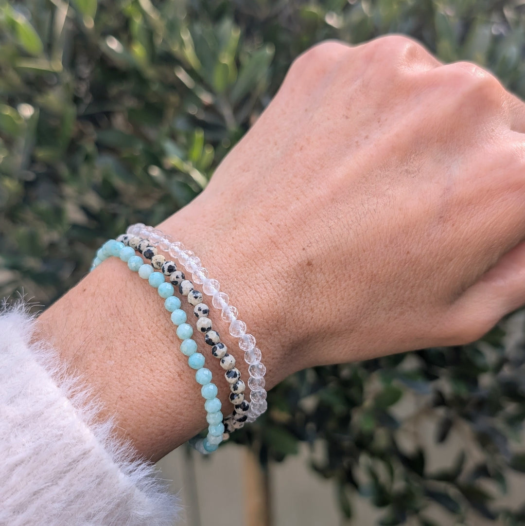 Health and wellbeing gemstone bracelet set comprising dalmatian jasper, clear quartz and amazonite bracelets.