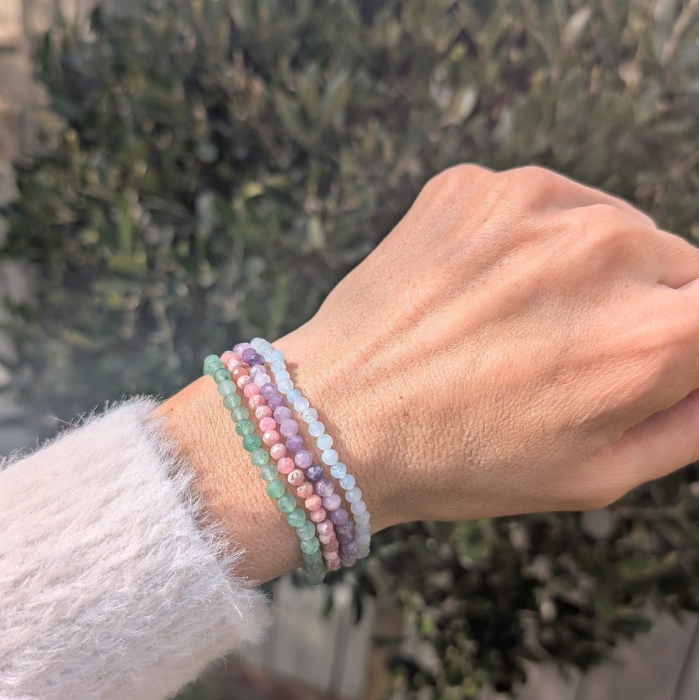 Good luck gemstone bracelet set comprising rhodochrosite, lepidolite, green aventurine and aquamarine bracelets.