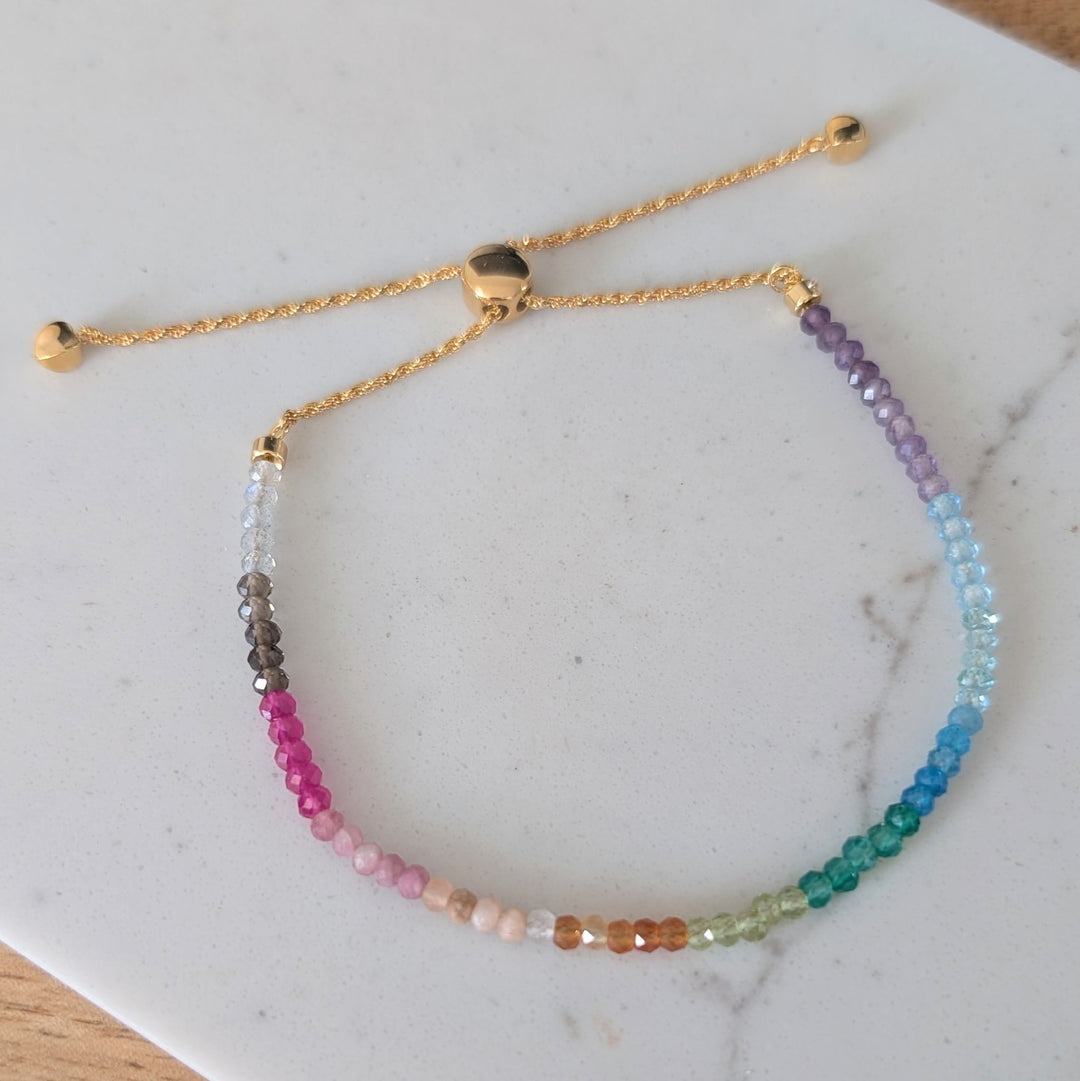 Multicolored rainbow gemstone beaded bracelet on a gold chain 
