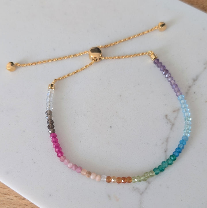 Multicolored rainbow gemstone beaded bracelet on a gold chain 