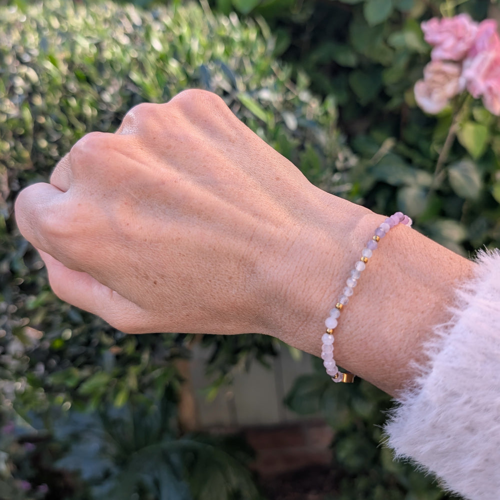 A beaded Libra zodiac stretch bracelet featuring labradorite, lepidolite and rose quartz faceted gemstone beads.