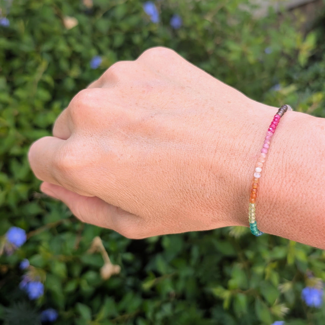 Multicolored rainbow gemstone beaded bracelet on a gold chain 