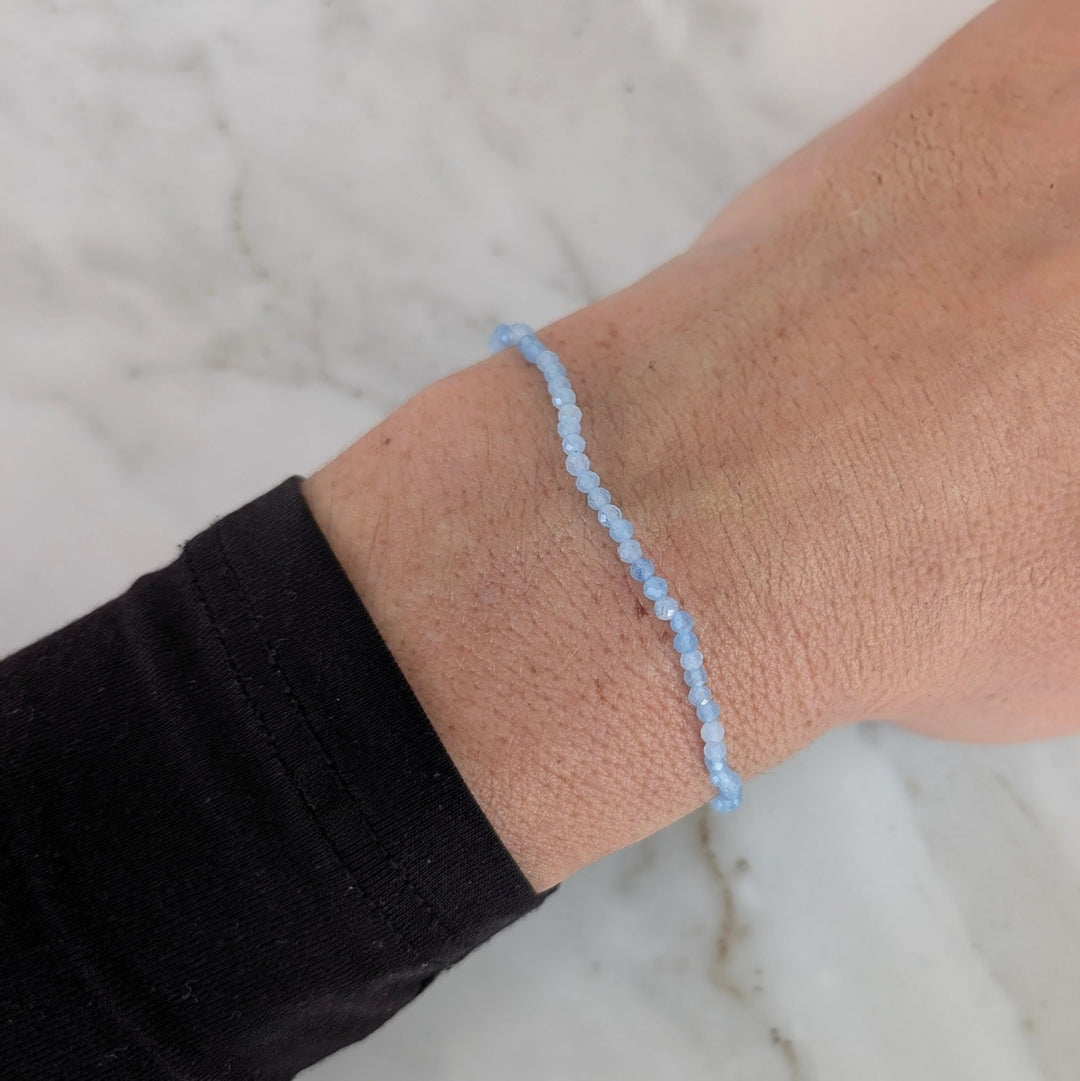 Light blue beaded aquamarine bracelet with a silver charm 