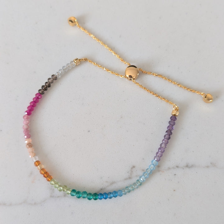 Multicolored rainbow gemstone beaded bracelet on a gold chain 