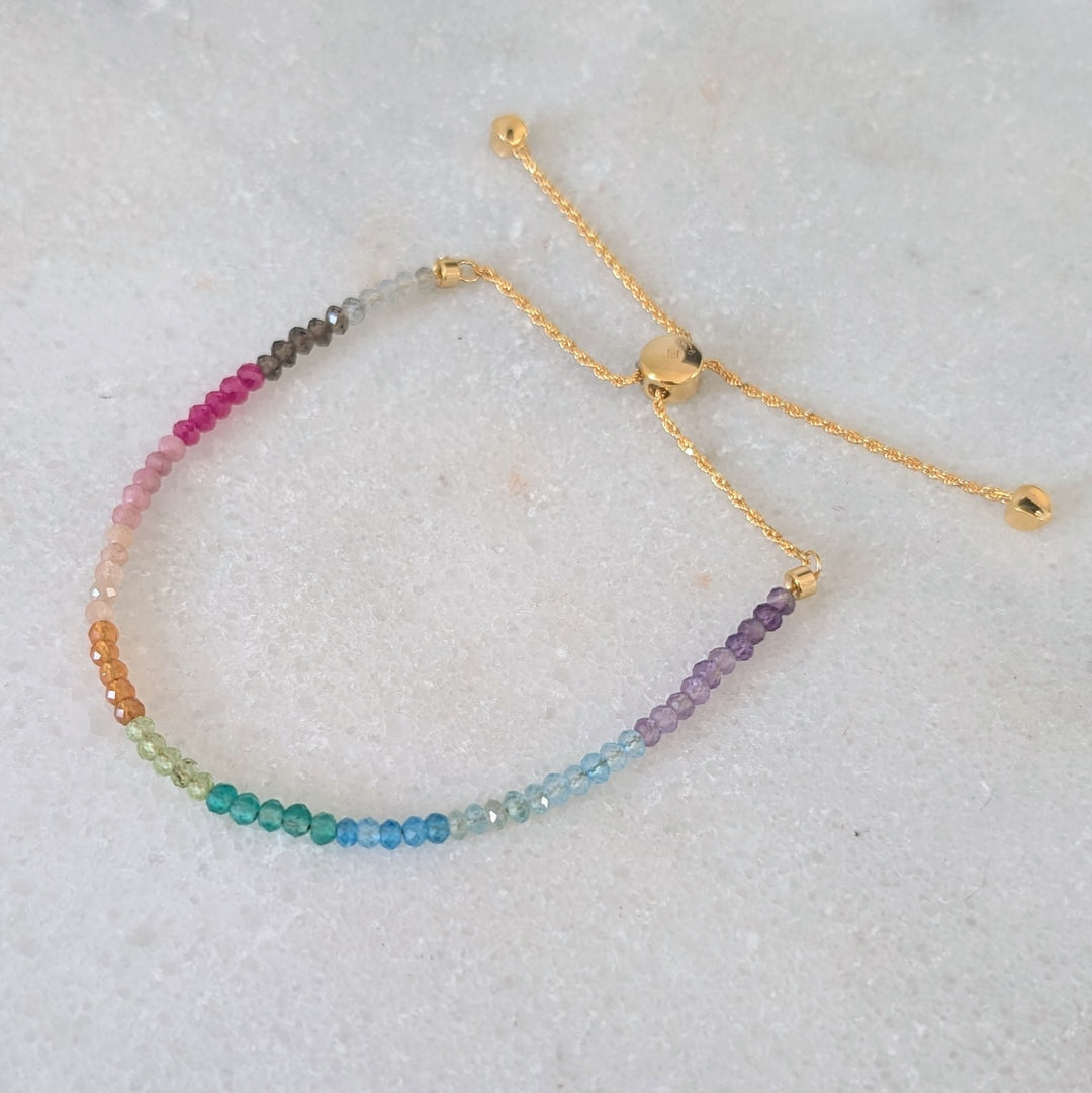 Multicolored rainbow gemstone beaded bracelet on a gold chain 