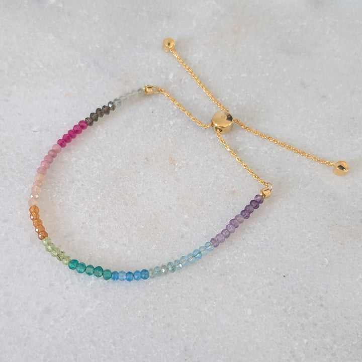 Multicolored rainbow gemstone beaded bracelet on a gold chain 