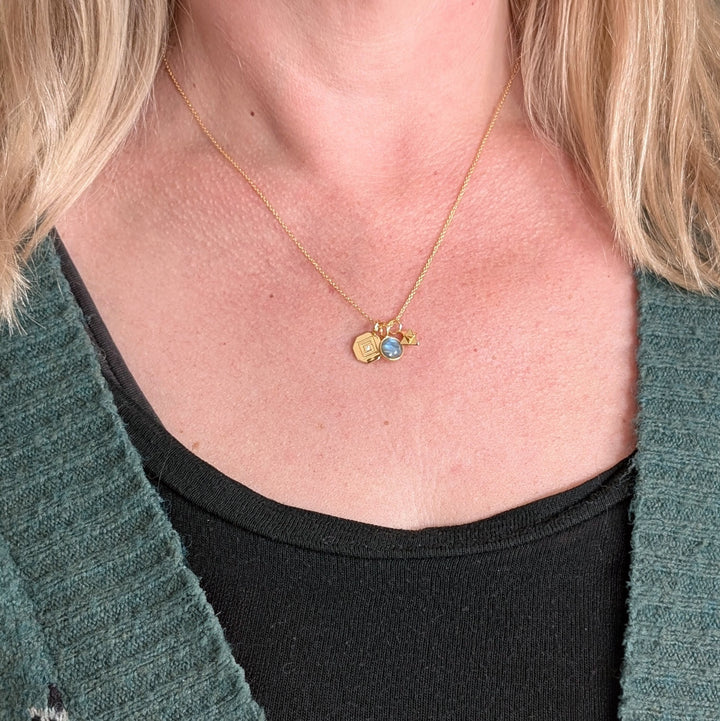 gold celestial necklace with labradorite, tetrahedron star and disc charms on model