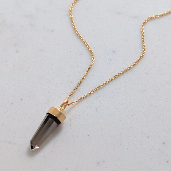 Gold necklace with a smoky quartz spike pendant 