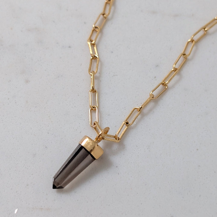 Gold paperclip necklace with a smoky quartz spike pendant 