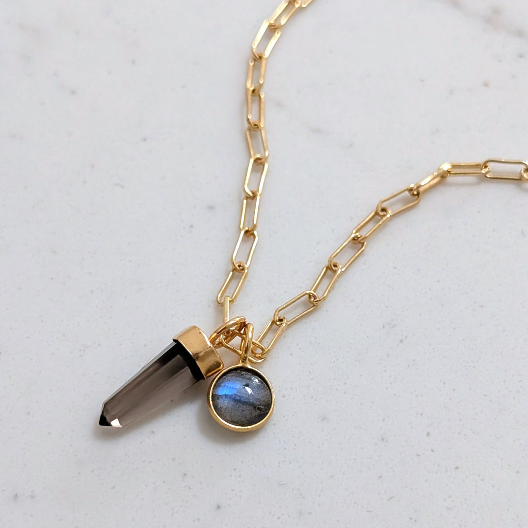 Gold paperclip necklace with a smoky quartz spike pendant and labradorite charm