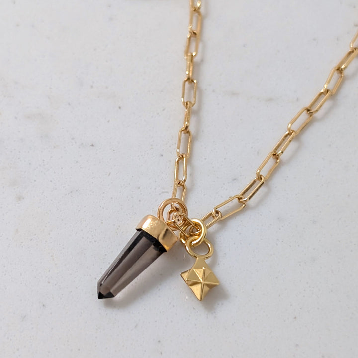 Gold paperclip necklace with a smoky quartz spike pendant an tetrahedron star charm
