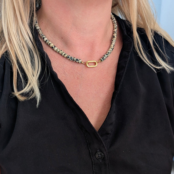 A 6mm beaded dalmatian jasper gemstone necklace, featuring a gold oval lobster clasp.