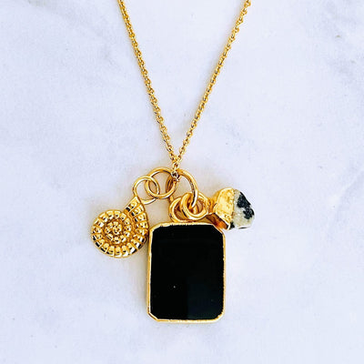 Gold plated black onyx, dalmatian jasper and smmonite charm pendant necklace