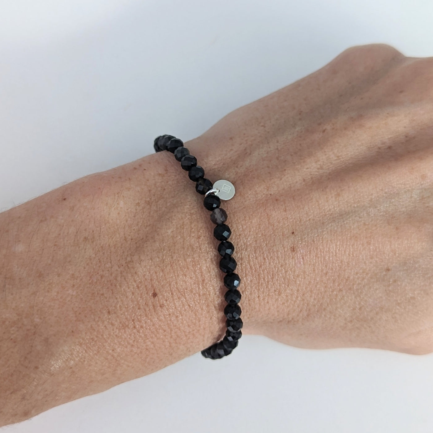 Obsidian 4mm faceted gemstone bracelet with sterling silver circular disc